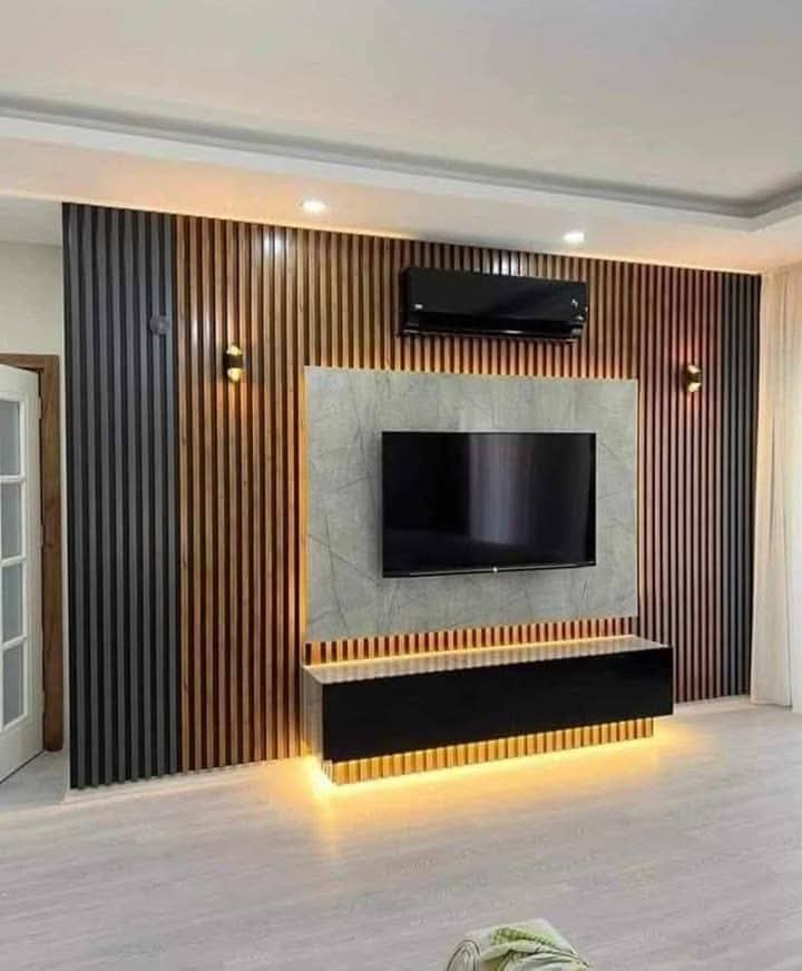 TV feature wall with built-in cabinetry and concealed lighting in a Doha living room (view 2)